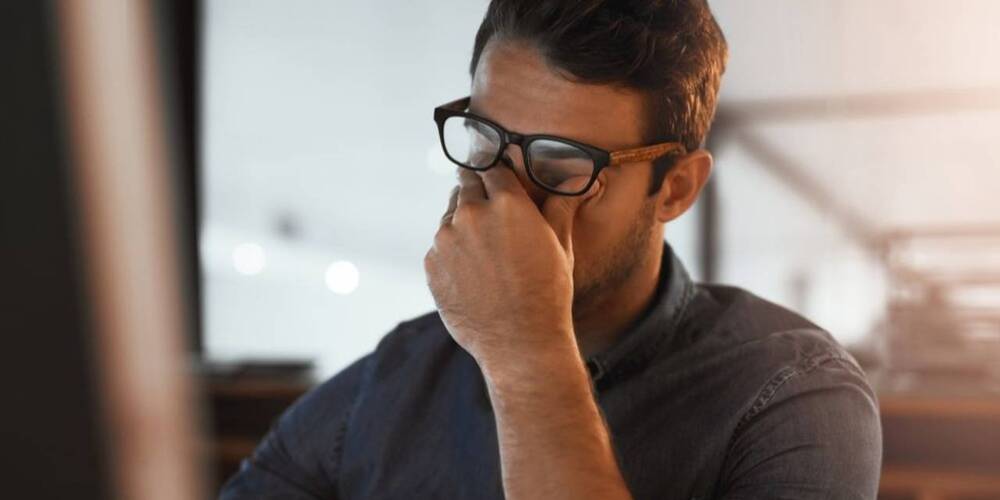 Man with hand on face