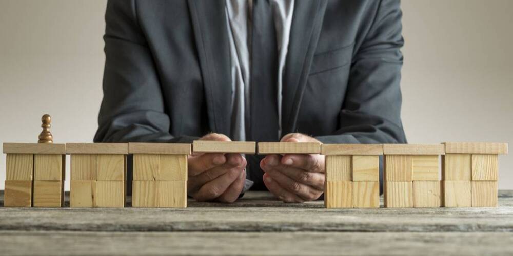 man in suit moving blocks