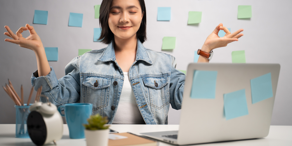 Woman meditating at her desk