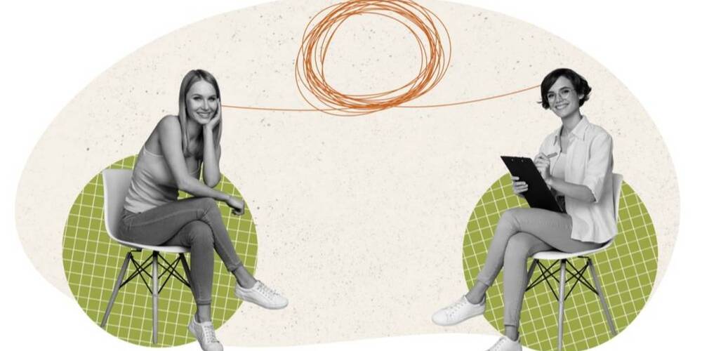 2 women sat opposite each other smiling